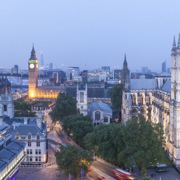 London landmark, Big Ben clock tower and the Houses of Parliament, view from above at dusk. The London Eye, Millennium Wheel and River Thames. Westminster Abbey.